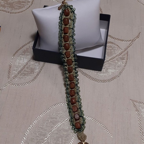 Handmade bracelet with brown wooden beads and light green glass