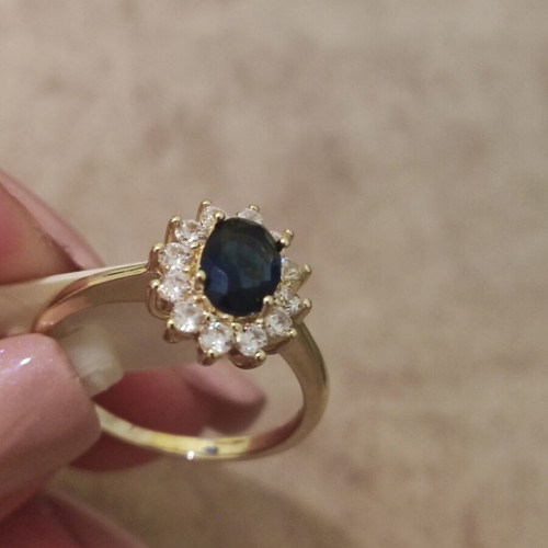 Women's rosetta ring new, gold color with blue oval stone and zircons
