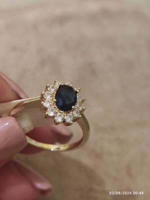 Women's rosetta ring new, gold color with blue oval stone and zircons