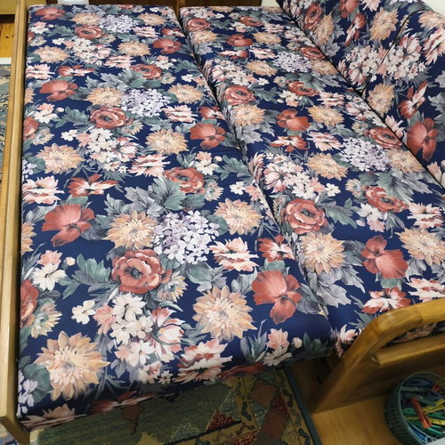 Three-seater sofa with pull-out bed and floral upholstery