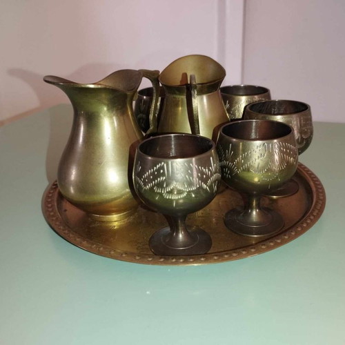 Vintage brass set with jugs, glass, and vase from India