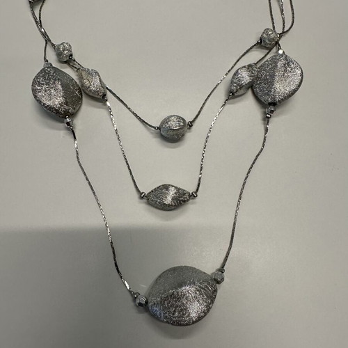 Triple necklace with silver pebble-like elements