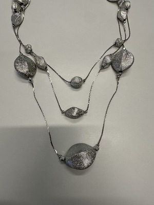 Triple necklace with silver pebble-like elements