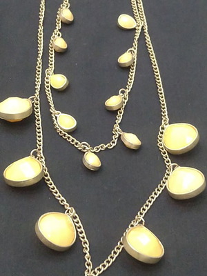 Double long necklace with matte gold chain and beige decorations