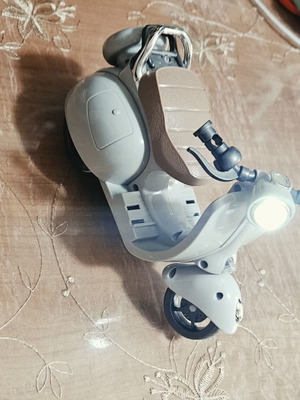 Toy motorcycle for dolls, plays music and moves