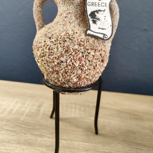 Handmade ceramic amphora decorative vase on metal base used