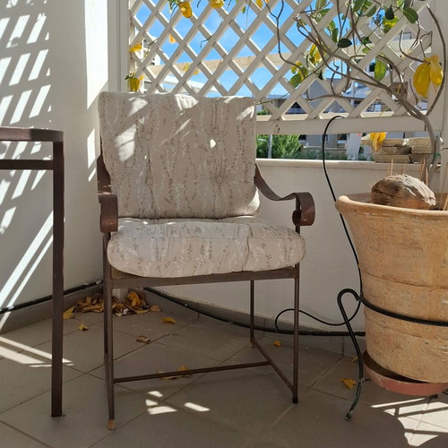 Retro wrought iron garden armchair with cushions used