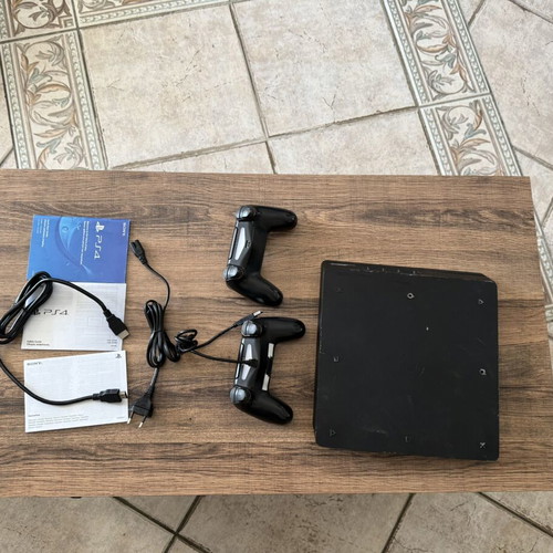PlayStation 4 Slim 500GB used with 2 DualShock 4 controllers and accessories