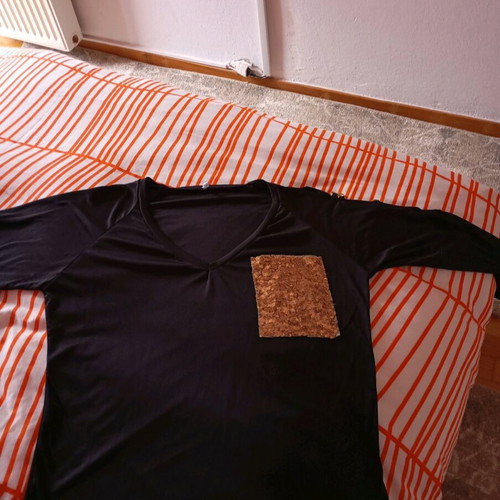 Black elastic blouse with sequin pocket and cutout, like new