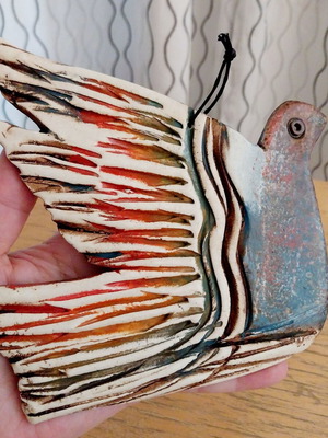 Ceramic decorative dove like new with multicolored feathers