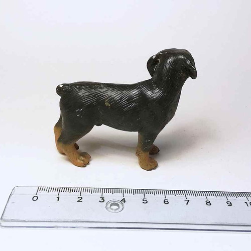 Plastic dog figure used with scratches and marks
