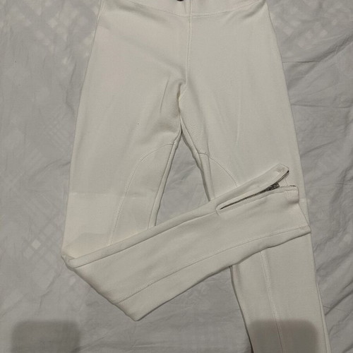 White elastic slim fit pants with ankle zippers