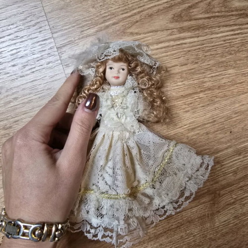 Glass bride doll like new with hat and lace