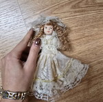 Glass bride doll like new with hat and lace