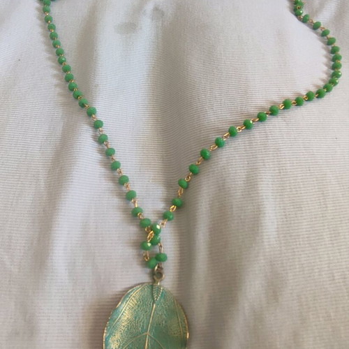 Long necklace new with beads and green leaf motif
