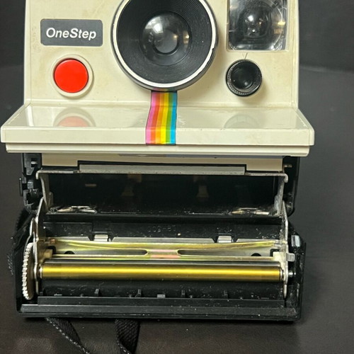 Vintage Polaroid One Step SX-70 camera and film used, white with rainbow stripe