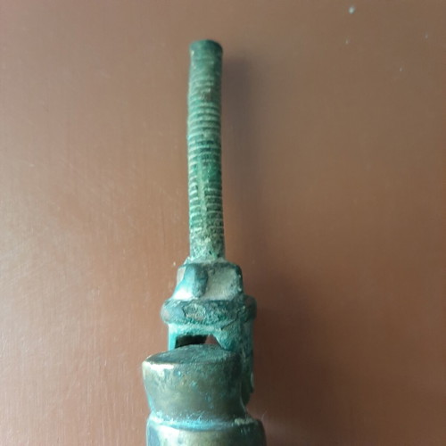 Antique bronze door knocker in hand shape