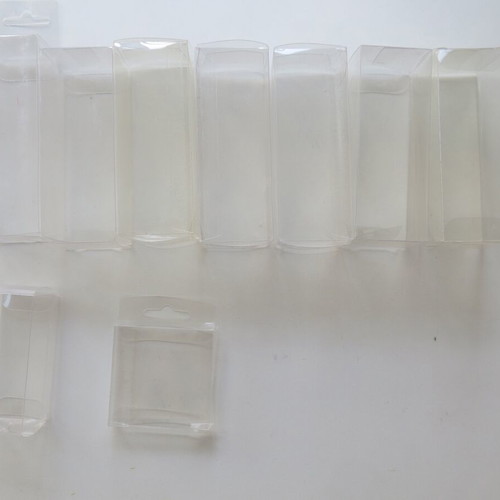 Plastic transparent cases used for figures and Game Boy