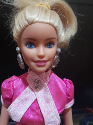 Barbie doll with outfit, earrings and stand used