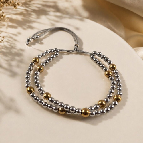 Double bracelet with silver and gold hematite beads, adjustable cord