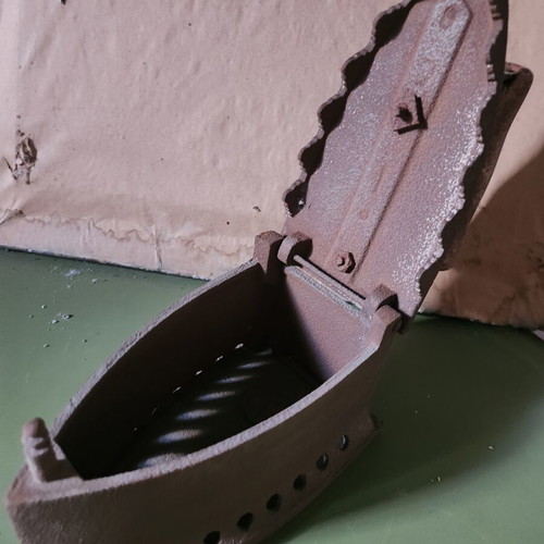 Charcoal iron used, traditional cast iron with wooden handle