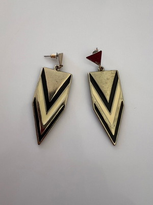 Metal earrings used with signs of wear, black and gold