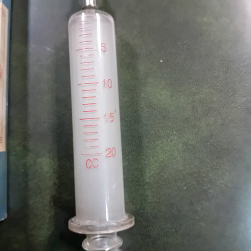 Antique glass syringe used with needle box