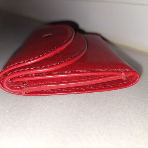 Small red wallet with coin and bill compartments