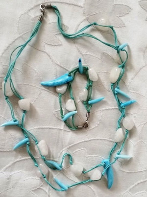 Handmade jewelry set with turquoise and white stones on blue cord