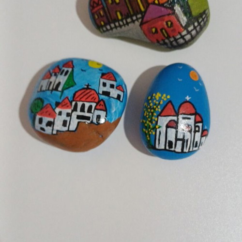 Set of painted pebbles with village motifs, new