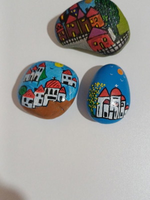 Set of painted pebbles with village motifs, new