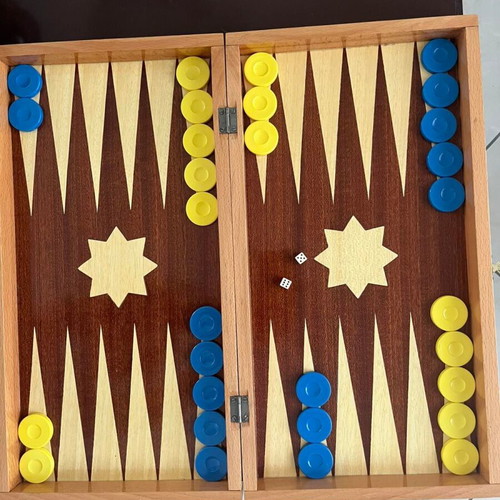 Wooden backgammon set used with colorful checkers and dice
