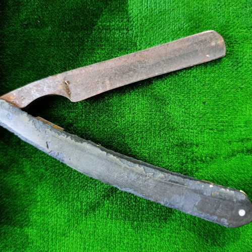 Vintage straight razors with leather strop and wooden handle