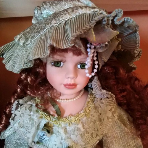 Porcelain doll with green eyes like new