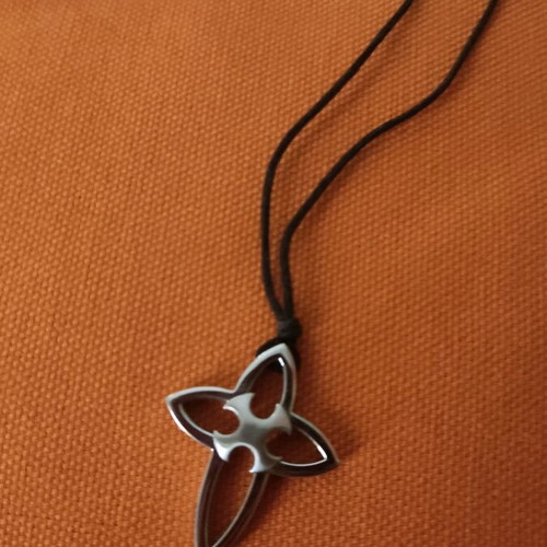 Pendant cross made of steel with cord in unique design like new