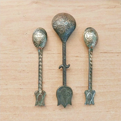 Decorative brass spoons with colored glass, set of three, used