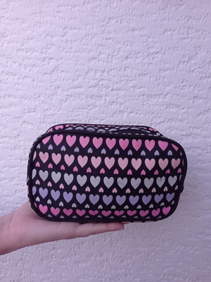 Toiletry bag used black with heart patterns
