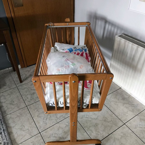 Wooden baby cot like new with wheels and mosquito net