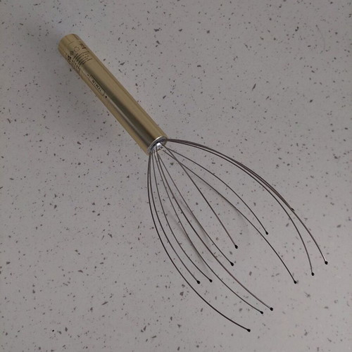 Head massager new, opened for battery placement