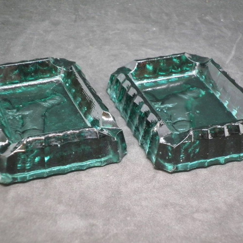 Antique ashtrays pair used with embossed dogs in dark green glass