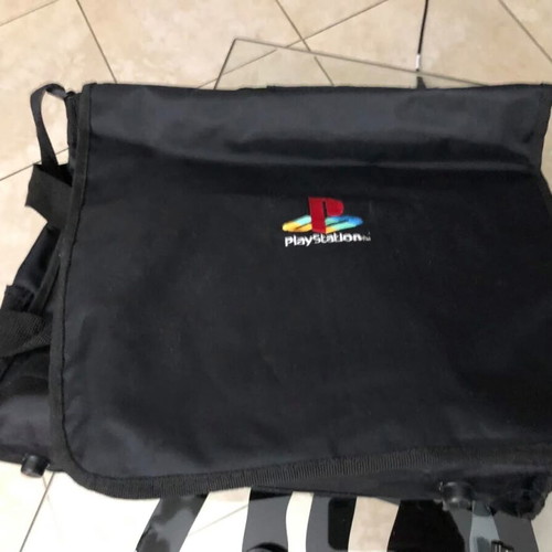Sony PlayStation console used with official bag, controller and cables