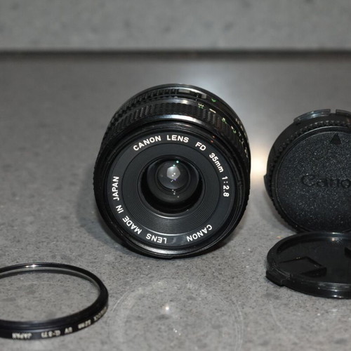 Canon A-1 collectible pack like new with Motor Drive, strap and 35mm f/2.8, 135mm lenses