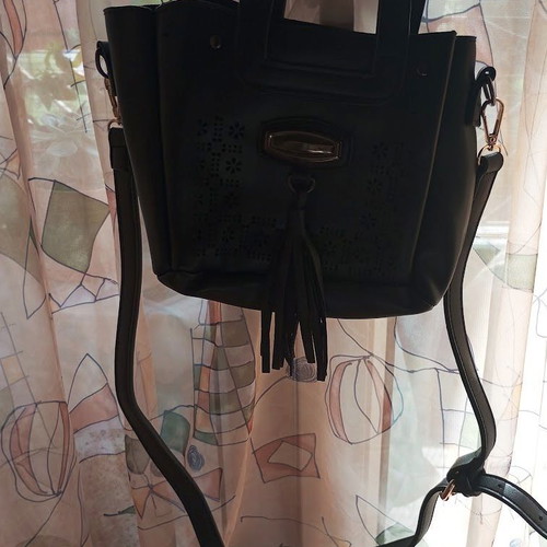 Black Women's Shoulder Bag like new with laser-cut patterns and tassels