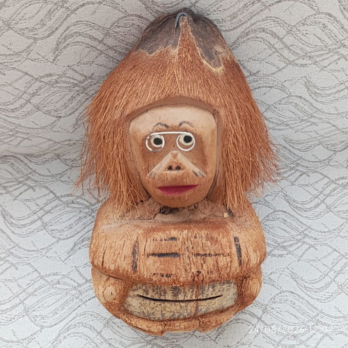 Handmade coconut shell money box with straw hat