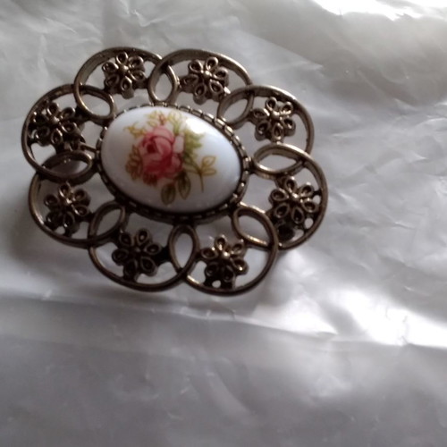 Metal brooch with porcelain detail used