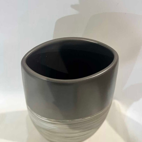 Modern ceramic conical vase with black and white striped design used