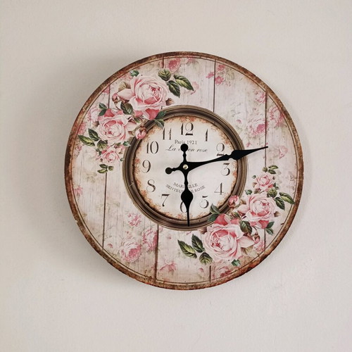 Decorative wall clock used, analog with floral design