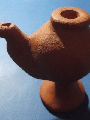 Clay oil lamp or water whistle with fleur-de-lis scouting emblem, used