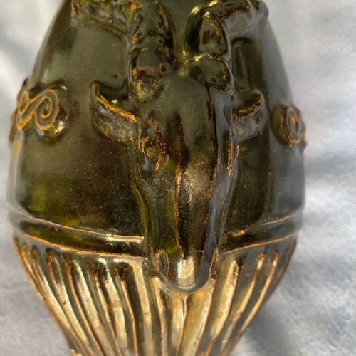 Black ceramic vase with ram’s head decoration