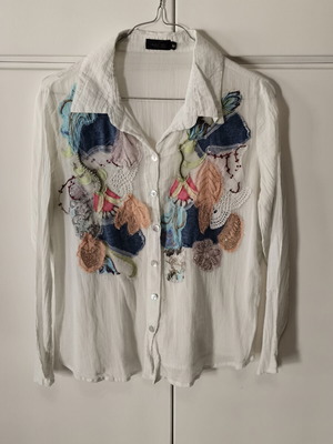 Laura Fiori semi-transparent white shirt with front designs used